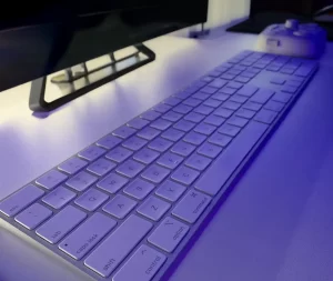 photo of apple wireless keyboard on white desk