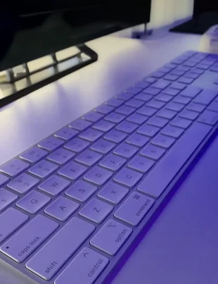 photo of apple wireless keyboard on white desk