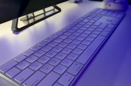 photo of apple wireless keyboard on white desk